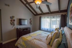 a bedroom with a bed and a ceiling fan at Radiator Springs by Funtierland Vacation Rentals in Anaheim +17 photos