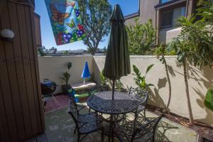 a table and chairs with an umbrella on a patio at Radiator Springs by Funtierland Vacation Rentals in Anaheim
