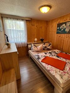 a bedroom with a bed in a wooden room at Bungalowdorf Briesensee in Neu Zauche