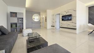 a living room with a couch and a tv at Tabarja Hills apartment in ‘Ayn aş Şughayrah +160 photos