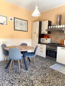 a kitchen with a table and chairs in a kitchen at Visilo Stone House in Pučišća