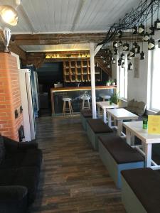 a restaurant with couches and tables in a room at Karusselli 1 Apartments in Pärnu