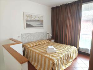 Ένα ή περισσότερα κρεβάτια σε δωμάτιο στο Bardolino Wein Apartments