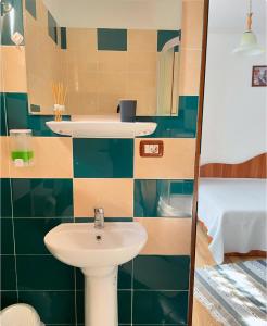 a bathroom with a sink and a mirror at Casa de vacanța Ariana in Borşa +39 photos