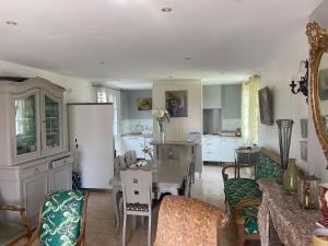a kitchen and living room with a table and chairs at gîte Joséphine in Attin +29 photos