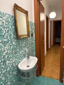 a bathroom with a sink and a mirror on the wall at Roiano Cinque in Trieste +33 photos