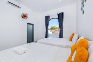 a bedroom with two beds and a teddy bear on the bed at Villa 17A1 Hồ Quý Ly,Gồm 5 phòng ngủ,Hồ bơi 45m2 in Vung Tau +49 photos