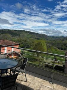 a balcony with a table and chairs and a view at Le Vallon Appartement T2 in Trébas