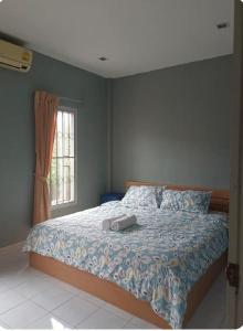 a bedroom with a bed and a window at The Endless Bangtao Residence TV2 AND TV 3 in Bang Tao Beach