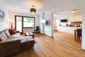 a living room with a couch and a kitchen at Ferienhaus Wolke 7 in Sankt Andreasberg