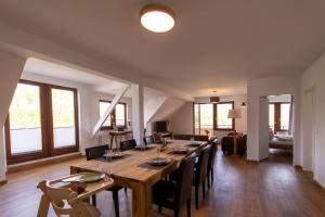 a dining room with a long table and chairs at Ferienhaus Wolke 7 in Sankt Andreasberg +36 photos