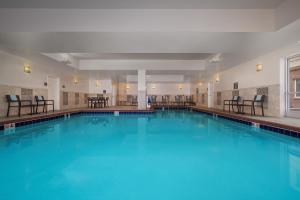 a large swimming pool with blue water at Residence Inn by Marriott Des Moines Downtown in Des Moines