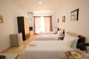 Ένα ή περισσότερα κρεβάτια σε δωμάτιο στο Blue Bay Apartments