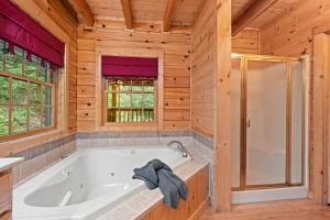 a large bathroom with a tub and a shower at Elk Rapids on Cosby Creek in Cosby +40 photos