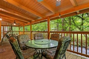 a screened in porch with a table and chairs at Elk Rapids on Cosby Creek in Cosby
