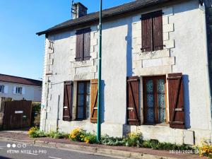 an old white house with wooden shuttered windows at FUTUROGITE in Saint-Georges-lès-Baillargeaux
