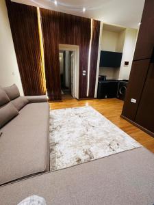 a living room with a couch and a rug at Urban Garden Retreat Cozy Studio and Private Patio in Cairo