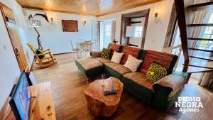 una sala de estar con un sofá y una mesa en Casa do Morro by PontaNegraAzores, en Agualva