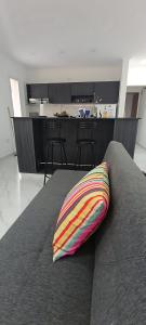 a colorful pillow sitting on a couch in a room at CasaPino Departamentos en Costa del Este in Costa del Este +10 photos