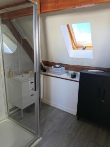 a bathroom with a sink and a mirror at hebergement centre ville Chateauneuf-en-thymerais in Châteauneuf-en-Thymerais