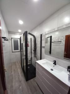 a bathroom with a shower and a white sink at Home from home in Noya