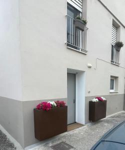 two flower boxes on the side of a building at A casa di Edo in Matera