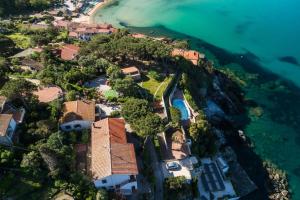 an aerial view of a house on a hill next to the ocean at Casa Sabrina in Portoferraio +22 photos