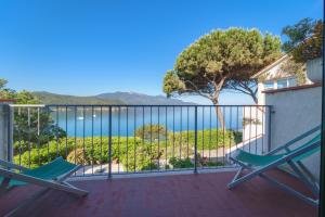 a balcony with two chairs and a view of the water at Casa Sabrina in Portoferraio
