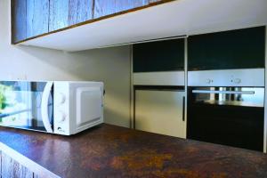 a microwave oven sitting on a counter in a kitchen at Apartment WG Zimmer Komplett Ausgestattet in Buchs