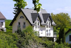 a large white house with a black roof at Gästehaus Waldecker in Boos