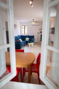 a living room with a table and a blue couch at Casa Carme in Camarles +10 photos