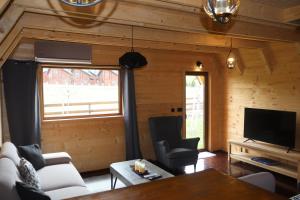 a living room with a couch and a tv at Portes du Soleil - Zabljak in Žabljak