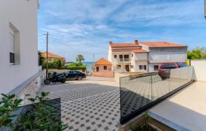 a glass balcony with a view of a parking lot at Villa Oliva Petrcane in Petrcane