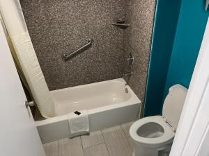 a bathroom with a toilet and a bath tub at 2 Double Beds Hotel Studio 234 in Livingston +5 photos