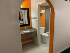 a bathroom with a sink and a toilet and a mirror at 2 Double Beds Hotel Studio 234 in Livingston