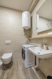 a bathroom with a washing machine and a sink at Arena BIG Luxury Apartments in Novi Sad +42 photos