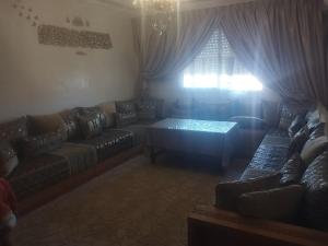 a living room with a couch and a table at Apartment Dar Salam in Marrakesh