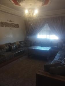 a living room with a couch and a chandelier at Apartment Dar Salam in Marrakesh