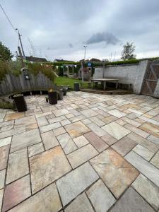 a patio with a bench and a picnic table at Large Home in South Dublin in Dublin