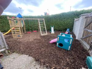 a playground with play equipment in a yard at Large Home in South Dublin in Dublin