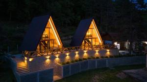 a house lit up at night with lights at Hedonizam in Zmajevac