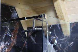 a glass shower in a bathroom with blue tiles at Portes du Soleil - Zabljak in Žabljak