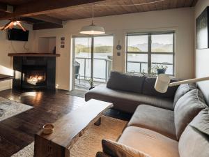 a living room with a couch and a fireplace at Island Vista - Waterfront Condo in Tofino