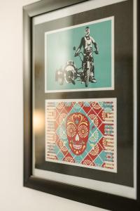 a framed picture of a skull and a picture of a motorcycle at Island Vista - Waterfront Condo in Tofino