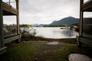 a view of a lake with a boat in the water at Island Vista - Waterfront Condo in Tofino