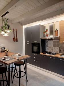 a kitchen with a wooden table and a counter top at Casa vacanza Il Mandarino in Viagrande