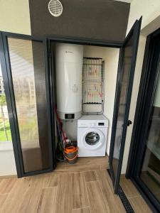 a washer and dryer in a room with an open door at Apartment Valentino Golf 3 in Villamartin