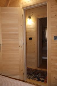 a wooden room with a door and a mirror at Portes du Soleil - Zabljak in Žabljak
