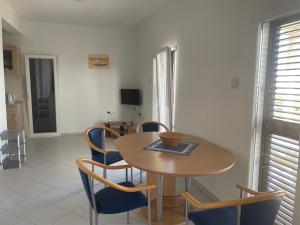 a dining room with a wooden table and chairs at Sunrise Sunset Seaview Walk to Vis Iconic Beaches in Rukavac