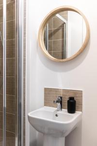 a bathroom with a sink and a mirror at Homestay Glan Llyn in Newport +35 photos